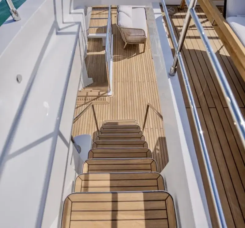 Foredeck sunpad and lounge seating shot from directly above, showing the beam carried well forward compared with a sportier flybridge design.