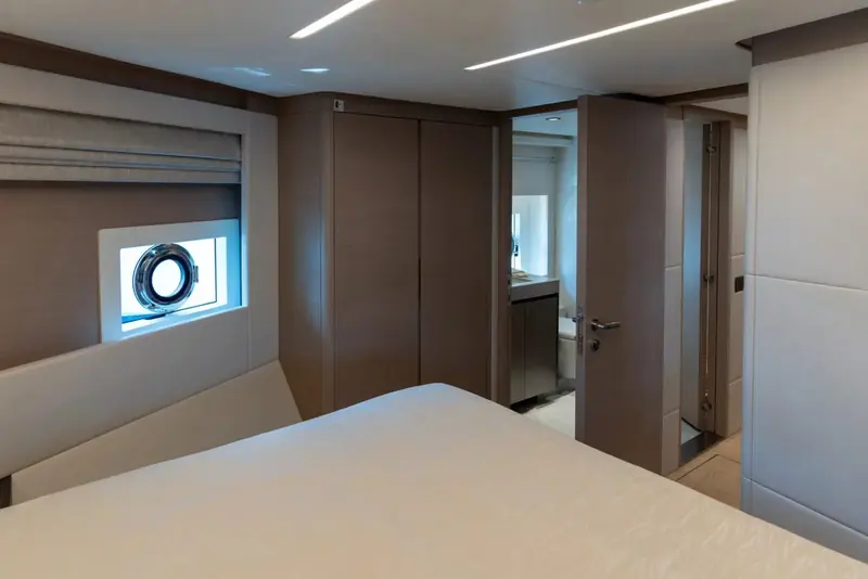 At rest in flat water, the swim platform and transom door visible at the waterline aft.