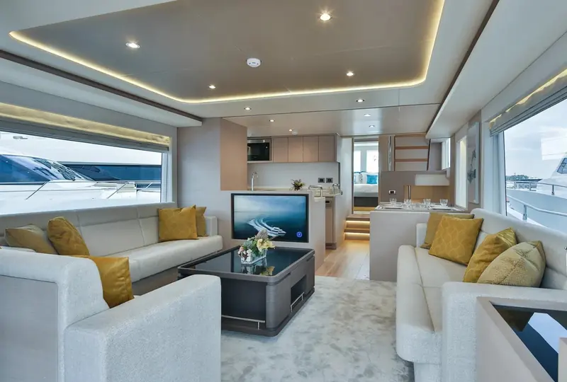 Bow view from the foredeck sunpad, white cushions and a folded towel laid out for guests before departure.