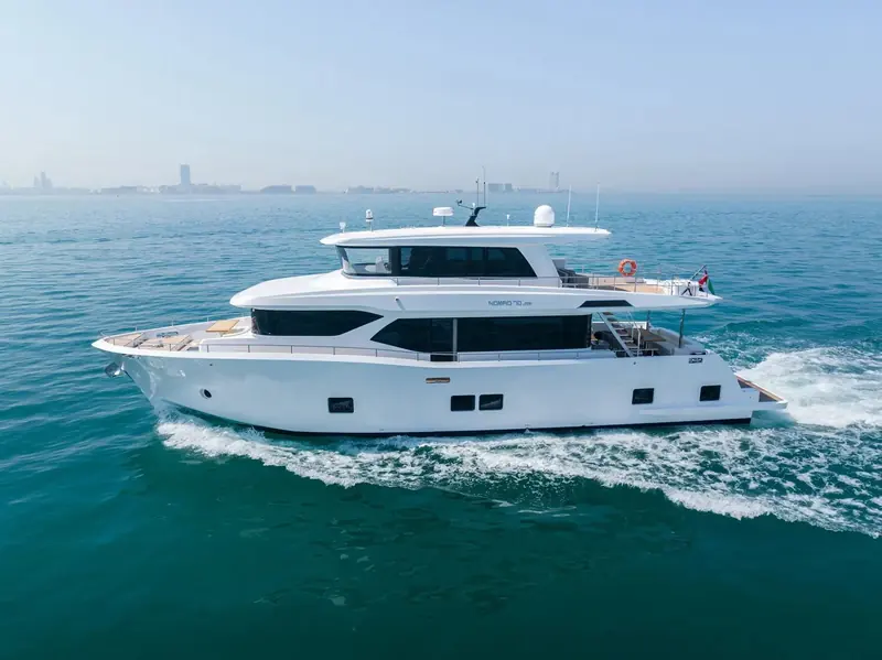 The same hull from abeam at speed, showing the long main-deck window band and the semi-displacement hull form the 2,000-mile range claim rests on.