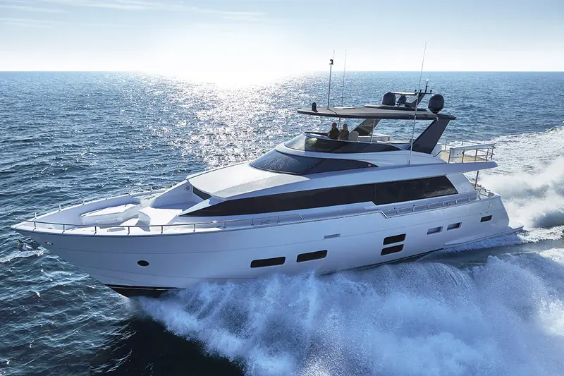 A Hatteras M75 Panacera running, two guests on the flybridge.