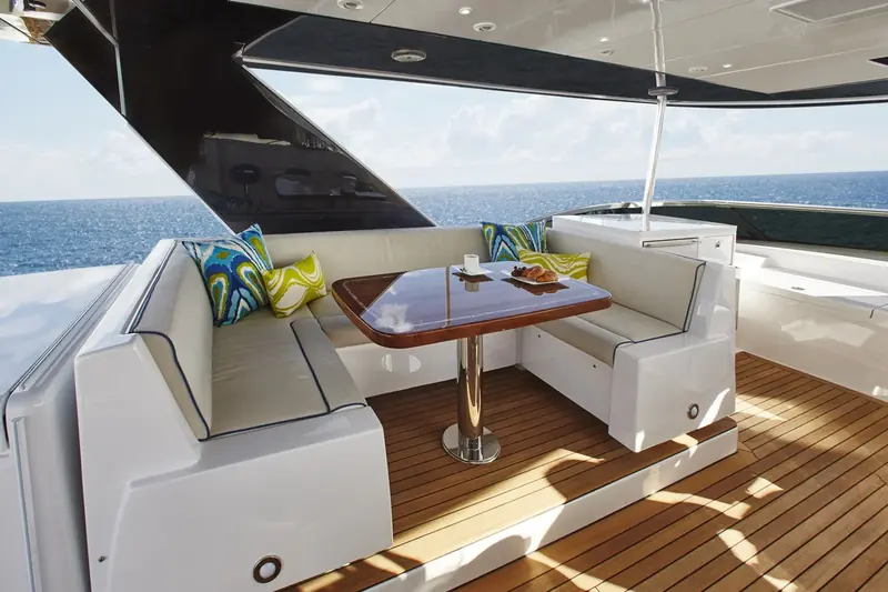 The M75 Panacera flybridge dinette, shaded under the hardtop.