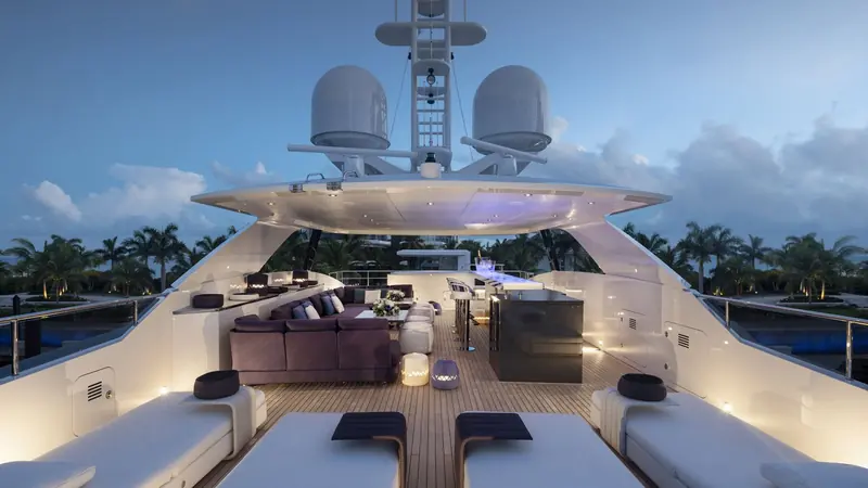 The sundeck runs the full length aft of the radar arch, laid out as an open lounge rather than split into separate seating pockets.