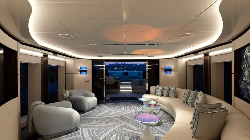 The main saloon at dusk, its curved sofa and swirled rug in a palette the owner chose personally with Cristiano Gatto.