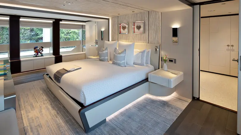 One of the lower-deck guest cabins, finished in the warm, residential tones that run through the whole interior.