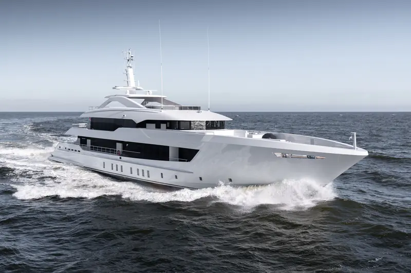 A bow-quarter running shot shows the vertical bow and full-beam foredeck lounge that the 55M Steel platform carries forward from her sistership Agnetha.
