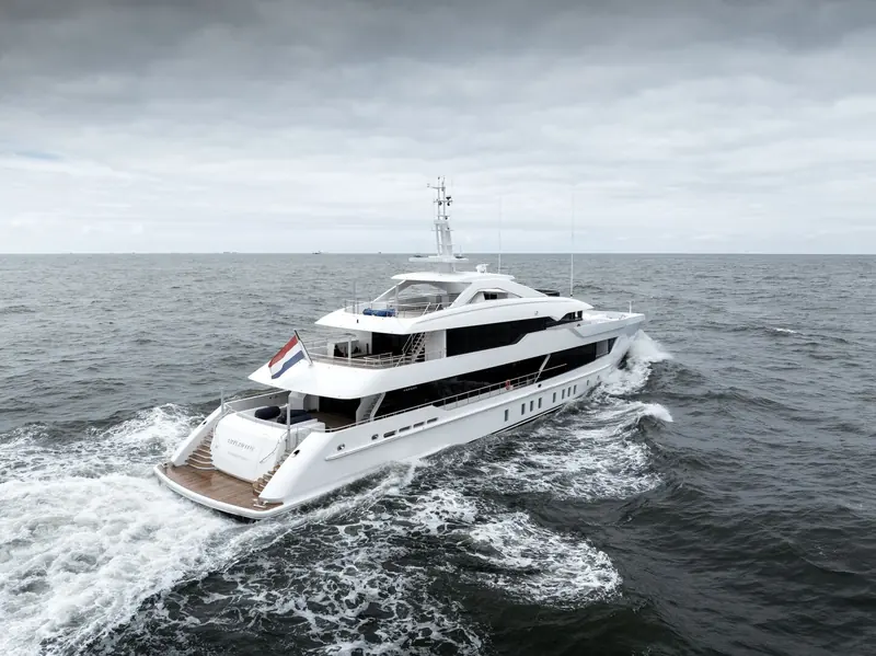 Closing on the transom with the tender platform down: her name Pa'lante and George Town port of registry are legible, confirming this is the christened yacht, not the pre-sale render.
