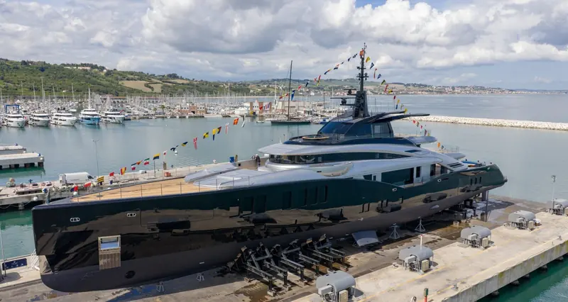 Dressed overall for her launch ceremony at ISA's Ancona yard, the full four-deck profile visible for the first time in daylight.