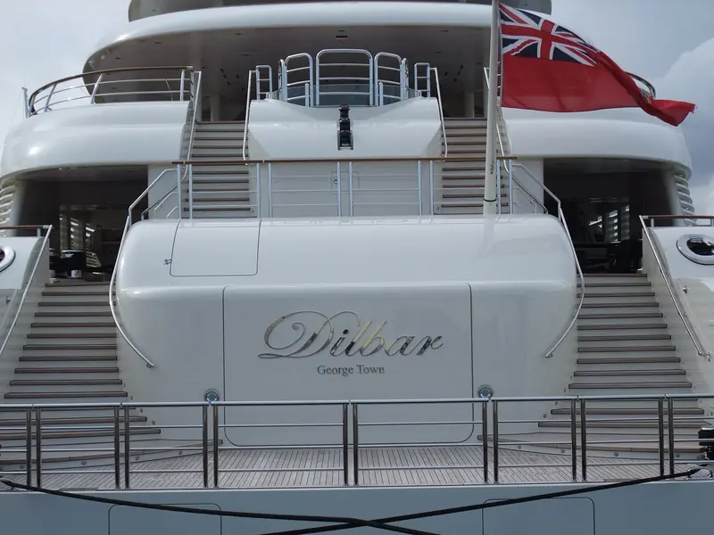 The nameplate on Dilbar's transom reads "Dilbar, George Town" - the Cayman Islands port of registry the yacht carries under its British ensign.