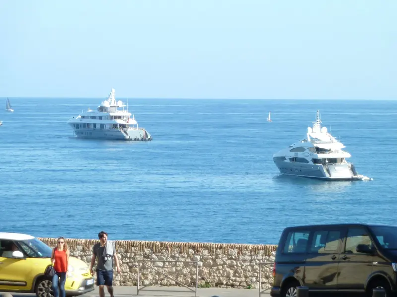 Anchored alongside another large yacht off Antibes, giving a sense of scale against a comparable hull.