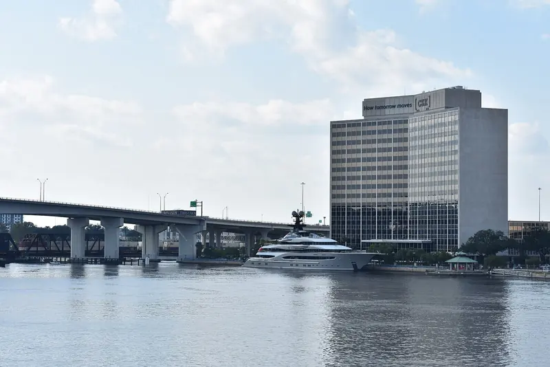 Kismet's port side at Jacksonville, showing the raked bow and the sun deck's radar and communications mast.