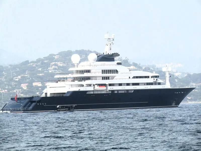 Underway off a Mediterranean coastline. The near-black hull and the twin domed radomes either side of the mast are the two things a spotter looks for first at any distance.