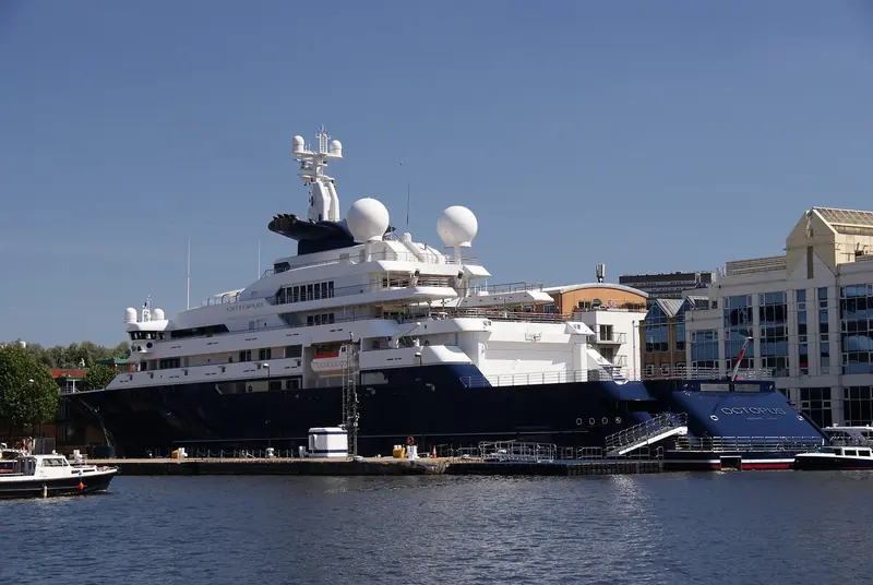 At anchor off Antibes with the old town and the Fort Carre behind her. Yachts of this size rarely fit inside the harbour itself and instead anchor off, visible from the ramparts.
