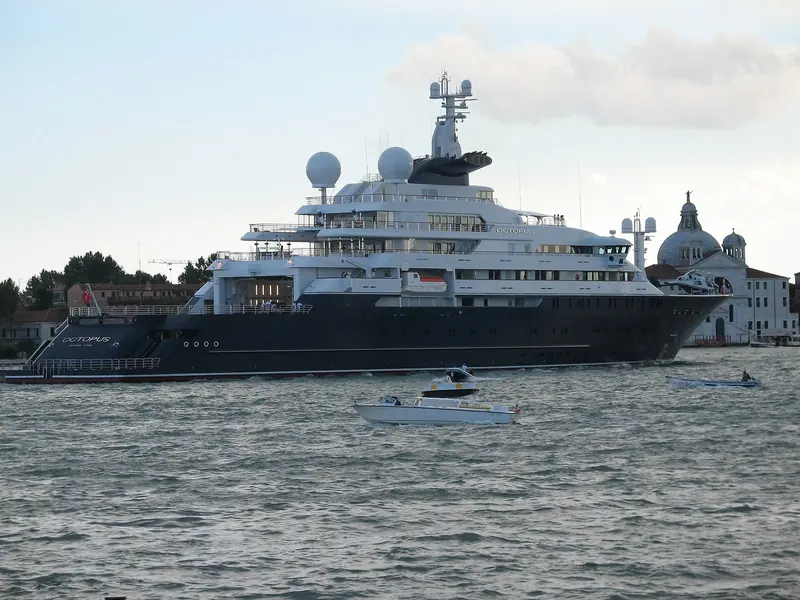 Moored off Venice with the city's rooftops behind. The helicopter hangar and pad sit forward of the twin radomes, one of two aviation decks built into the design.