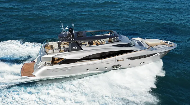 An MCY 105 underway at speed, the raised pilothouse and high bow that give the model its naval, superyacht-scaled profile clearly visible from above.