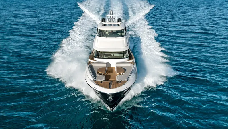 Head-on at speed, twin wakes either side showing the running trim on her standard MAN V12 engines.