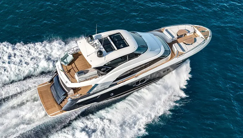 Cornering hard on trial, the teak-laid foredeck and side decks visible from above.