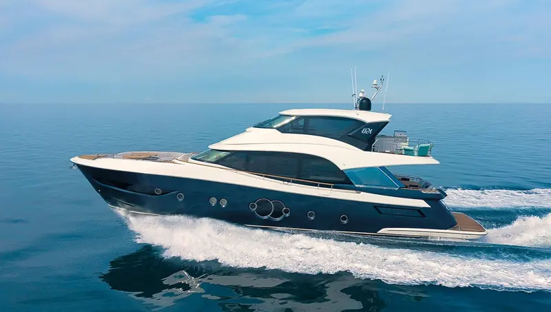 A broadside cruising shot showing the full profile: main deck, enclosed sky lounge and open flybridge stacked above the waterline.