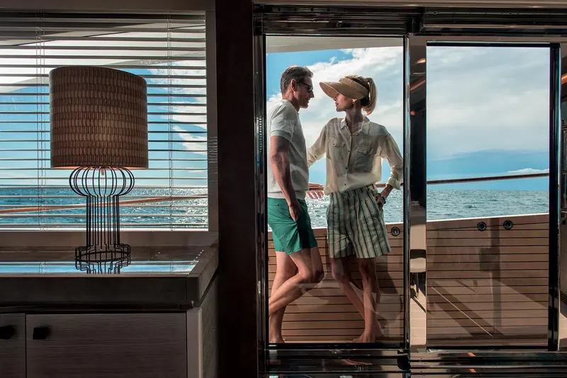 Owners stepping out onto Mia's aft deck teak from the main-deck saloon.