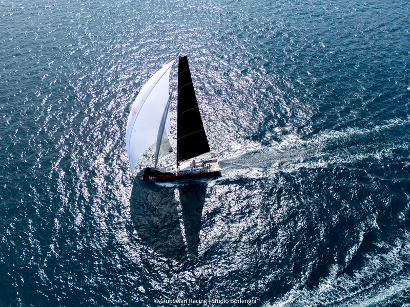 A ClubSwan 50 running downwind under spinnaker.