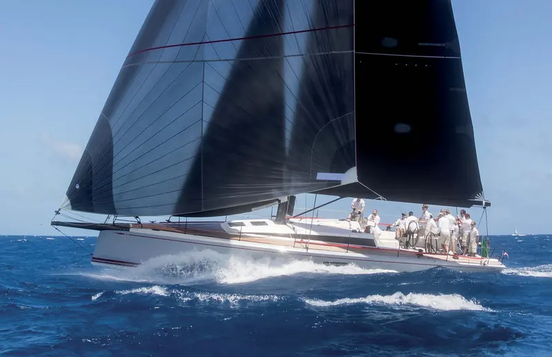 A ClubSwan 50 heeled hard upwind, crew hiked out on the rail.