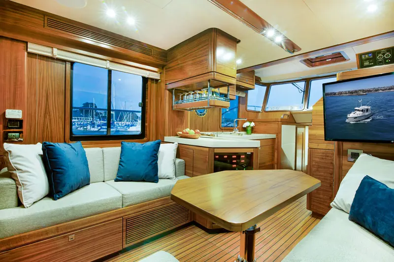 The Nordhavn 41 saloon and galley, finished in varnished teak.