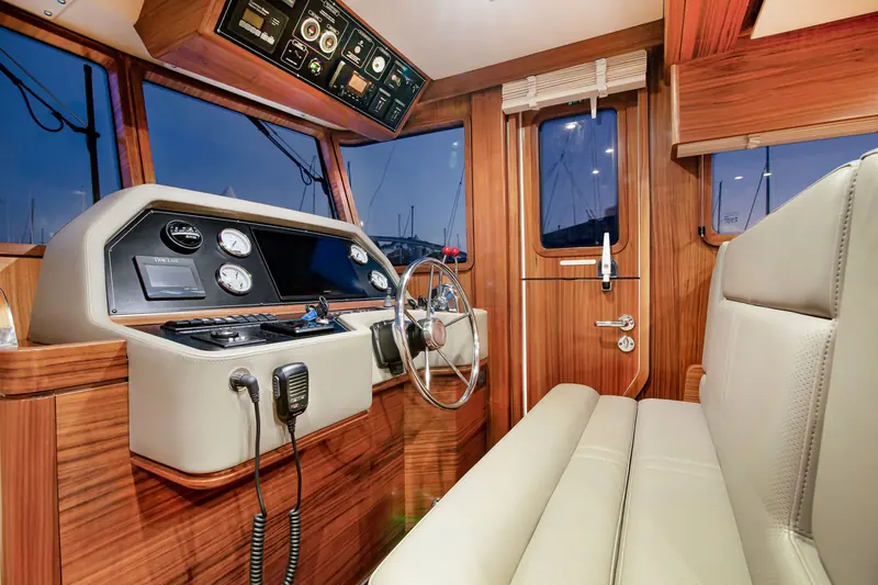 The Nordhavn 41 helm station, with the wheel and engine instruments to hand.