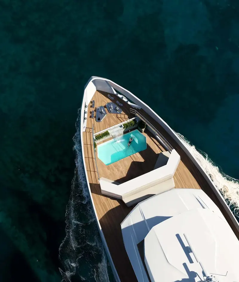 The foredeck lounge and plunge pool from directly overhead, showing how much usable deck space the reverse bow buys back on a 45-metre explorer hull.