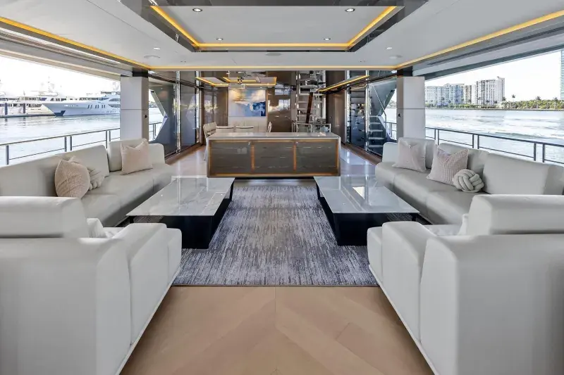 The 35R's main-deck saloon, finished with brushed metal trim and full-height windows on both sides.