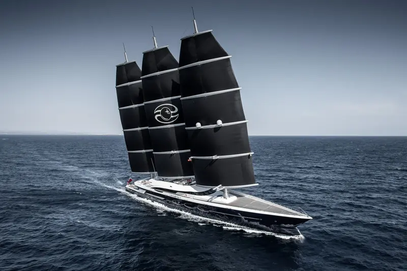 The 106.7-metre hull seen broadside, showing the low, dark superstructure Nuvolari Lenard drew to keep the DynaRig masts visually dominant.