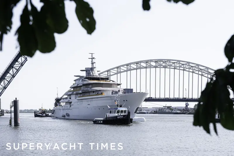 Leviathan under tow past the Noordhollandsch Kanaal bridge on transit from Oceanco's Alblasserdam shed, escorted by the tug Gepke, ahead of her August 2025 launch.