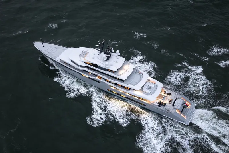 An overhead view of the 111-metre hull under way, showing the helipad marking forward and the tender/toy deck aft that Oceanco's design team built around Gabe Newell's crew-first brief.