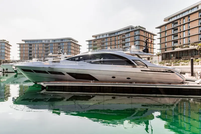 A Pershing 8X on her berth, the PERSHING 8X lettering legible on the topsides; carbon-fibre construction keeps a 25.5 metre hull this light on the water.