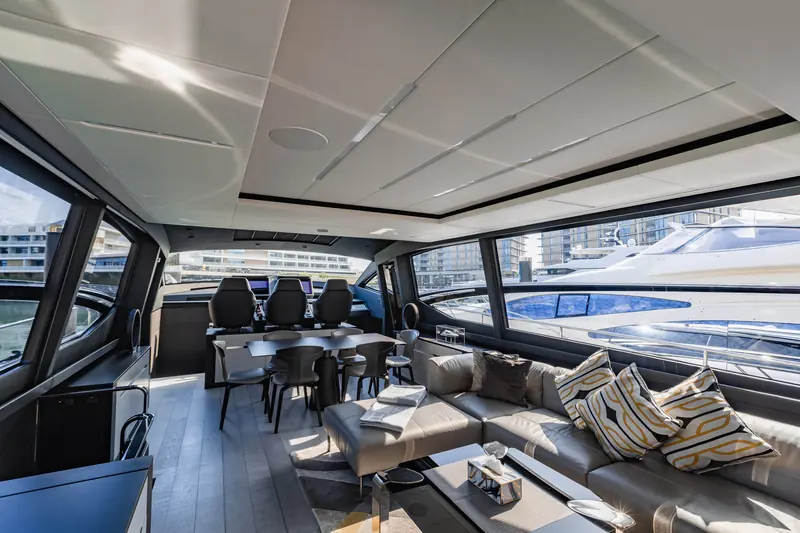 The saloon looking forward from the aft doors, helm seating and dash visible through the internal glazing.