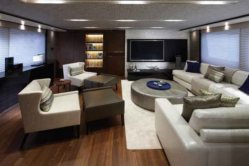 The enclosed sky lounge, with a built-in bookcase and wraparound sofa, doubling as a second saloon above the main deck.