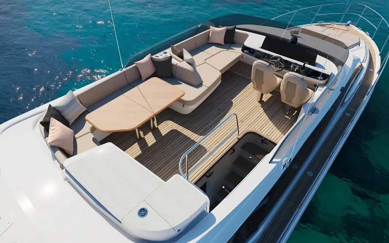 The cockpit from directly above: a two-helm-seat station, an aft-facing U-shaped settee round a teak table, and steps down to the bathing platform - the layout a buyer actually lives with at anchor.