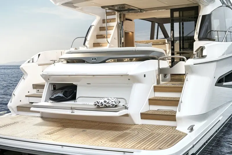 Cockpit and salon together, the glass door slid fully back so the aft deck and interior become one space at anchor.