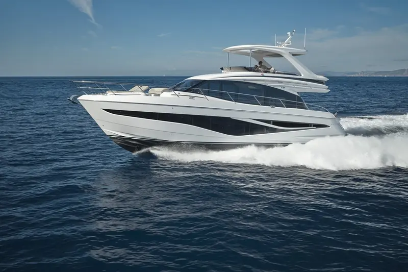 The F58 at speed against open water, the flybridge hardtop and radar arch giving the silhouette its raised, sporty profile.