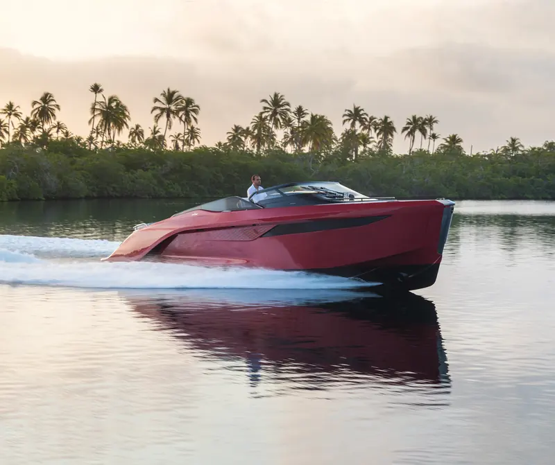 The R35 running hard through a mangrove channel at dusk, its carbon-fibre hull throwing a wide, unbroken wake.