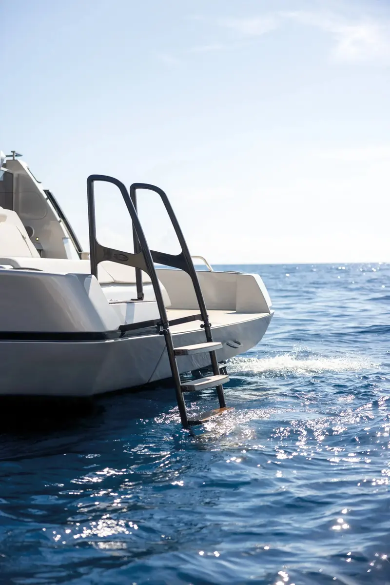 The folding boarding ladder deploys straight off the transom platform for swimmers, with no separate bathing ladder to rig.