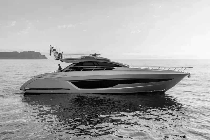 The Ribelle's low, fastback coupe roofline in profile at dusk, with the '66 Ribelle' nameplate visible on the topsides ahead of the cockpit.