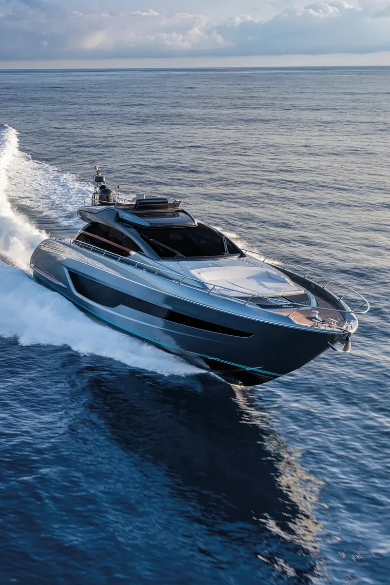 A following drone shot shows the sliding sunroof retracted over the helm and the foredeck sunpad, with the bow riding clear of the water at speed.