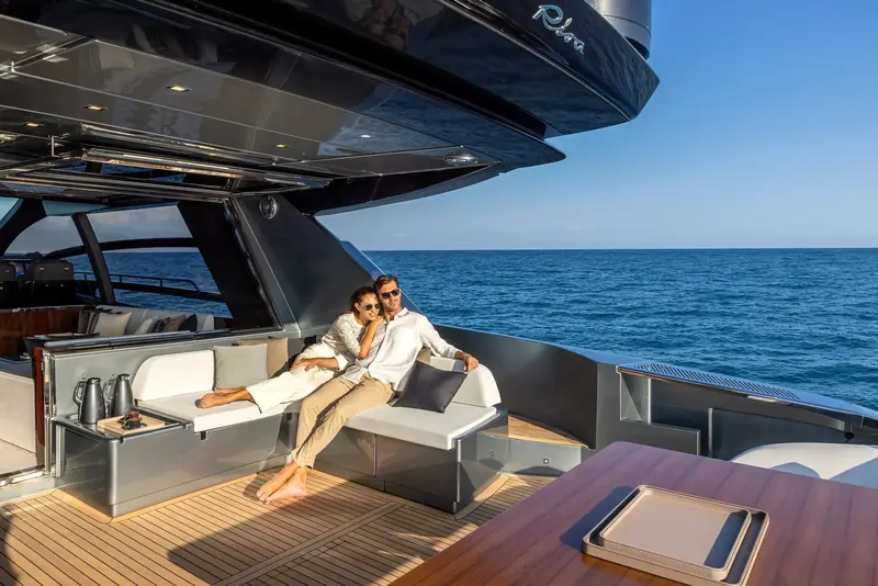 The aft cockpit at anchor, shaded under the retractable carbon roof that is the Perseo Super's signature over the standard Perseo.