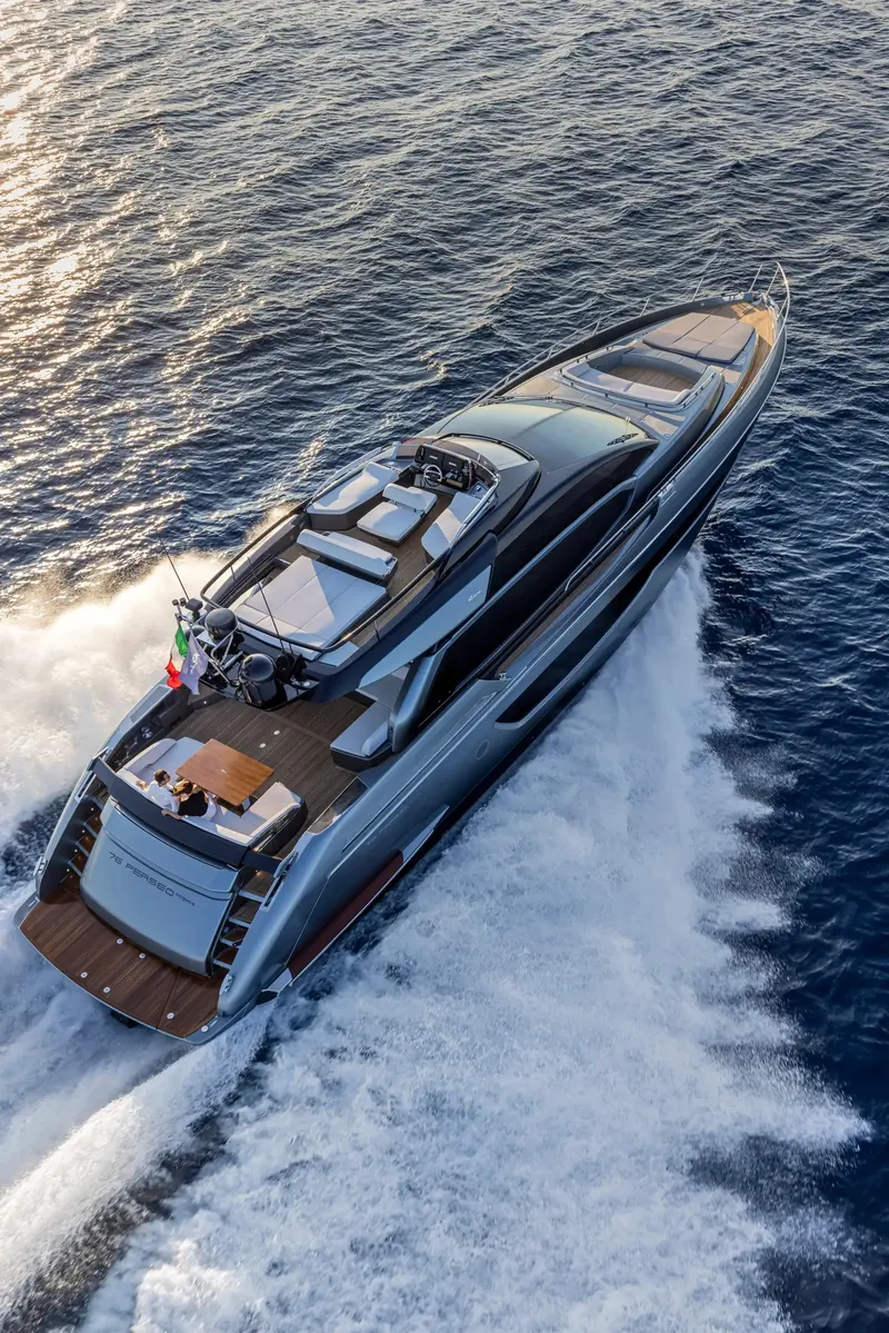 Running hard, the 76 Perseo nameplate visible on the transom; twin MAN engines put the standard boat at 32 knots.