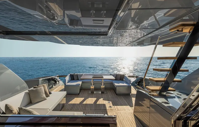 The sunken aft lounge and dining table, with the stairway up to the flybridge on the starboard side.