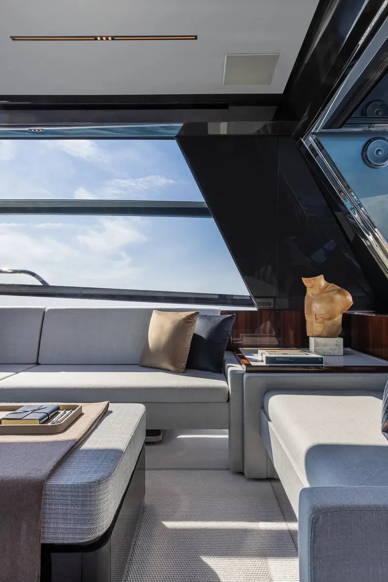 The saloon's low, wide side glazing, one of the largest window areas Riva has fitted to a yacht this size.