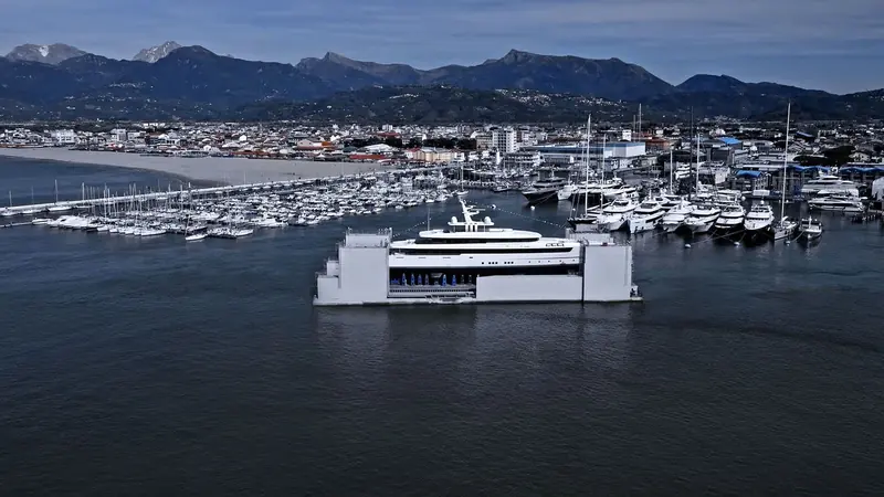 Lasata alongside in a Mediterranean marina, dwarfing the sportfishers and sailing yachts around her berth and giving a true sense of her length against other craft.