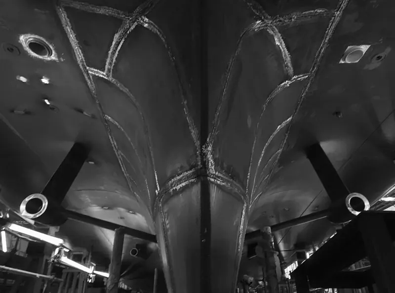 The welded steel bow structure under construction at Sanlorenzo's yard, showing the reinforced framing behind the ice-capable hull before paint and outfitting.