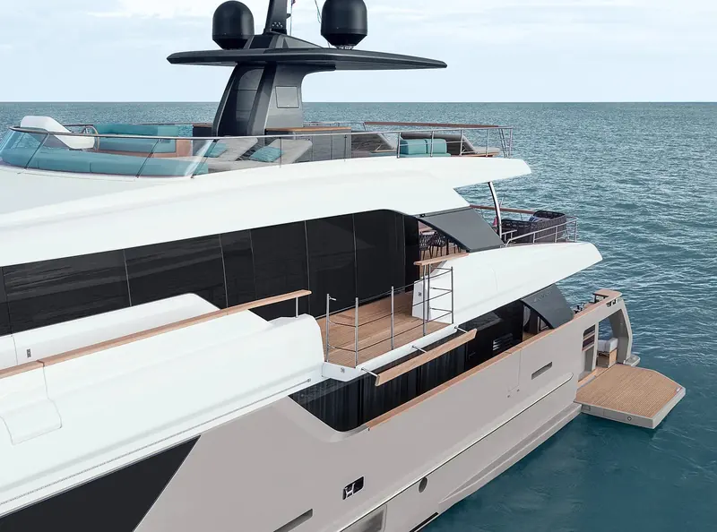 The transom folds down to a bathing platform at the waterline, with the tender garage doors visible either side of the aft deck steps.