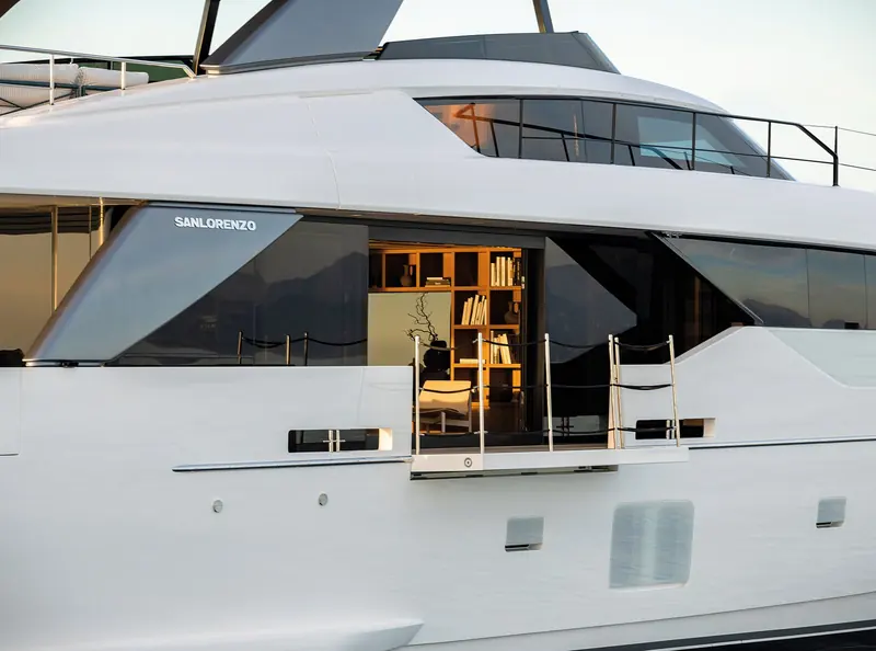 A close view of the aft superstructure, showing the Sanlorenzo nameplate and the glazed doors onto the side deck.